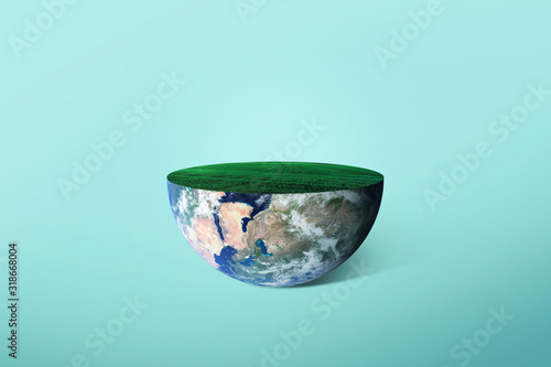 Fototapeta Naklejka Na Ścianę i Meble -  Half of the planet Earth with grass on a green background. Concept of the ecology of the planet. Creative idea