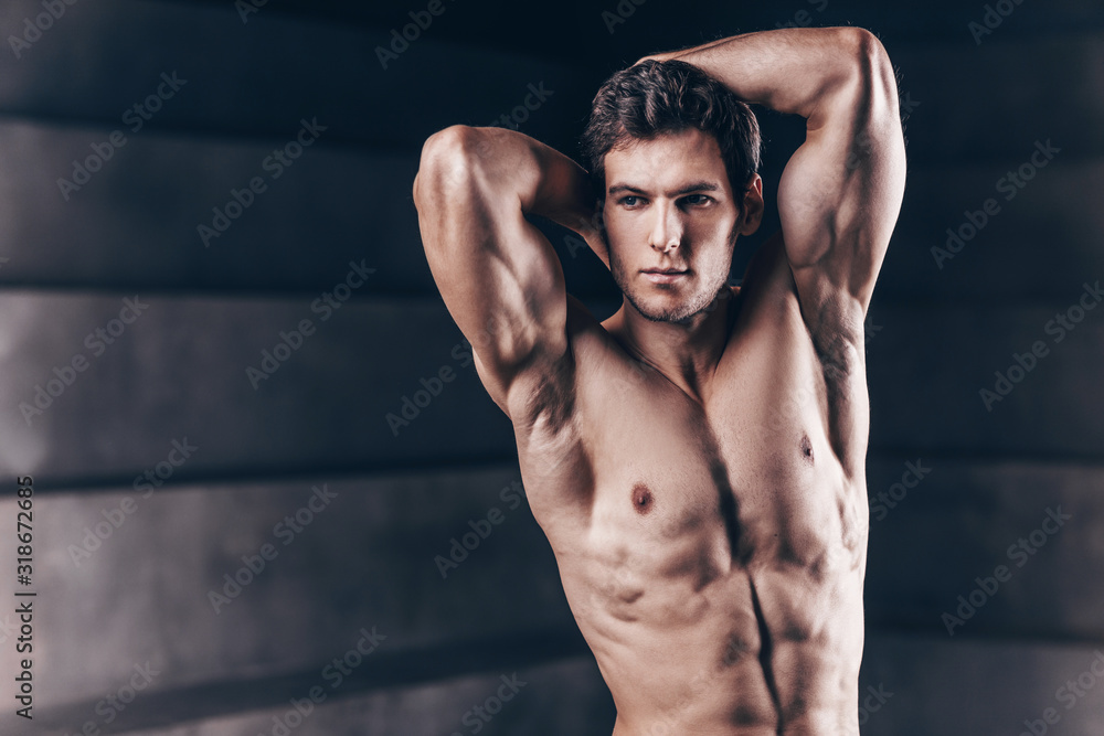 Handsome strong man posing in the studio.