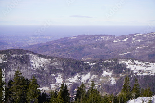 Panoramic view of winter and snowy landscape from the observation platform at the peak of a mountain in Szczyrk, Skrzyczne localization Beskid Mountains. Screensaver, copyspace or natural background.