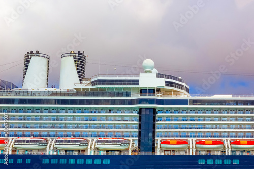 A view of a large cruise ship docked along the waterfront of Bahamas.