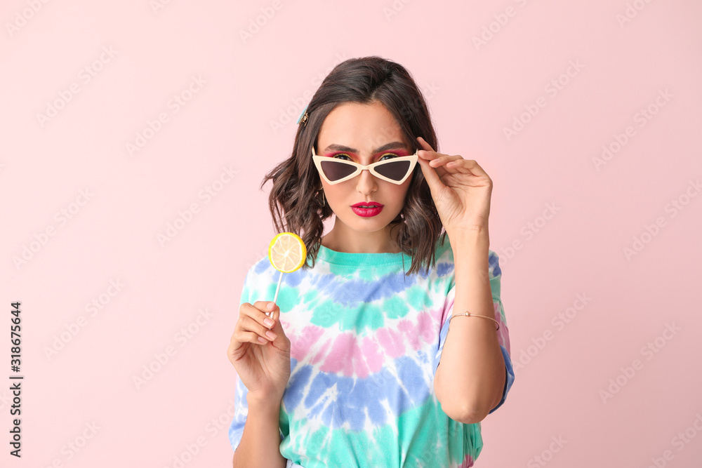 Beautiful young woman with lollipop on color background Beautiful young woman with lollipop on color background