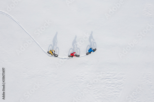 Obraz na płótnie Aerial drone photo of a group of friends riding their fat bike in the snow in Ontario, Canada w salonie