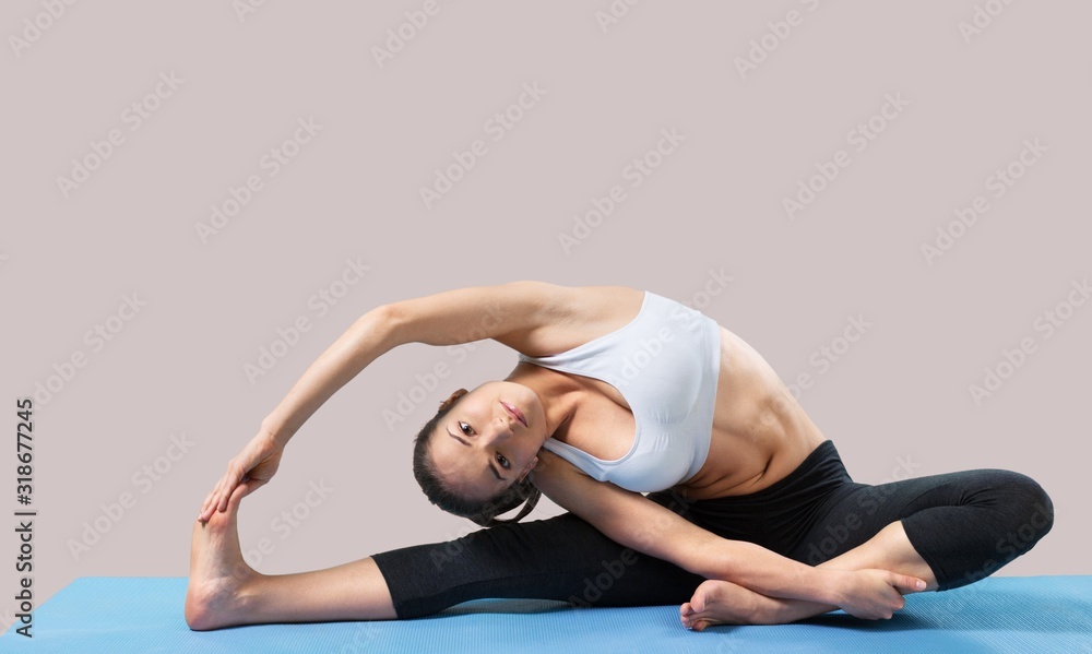 Obraz premium Young beautiful woman doing Yoga on the floor