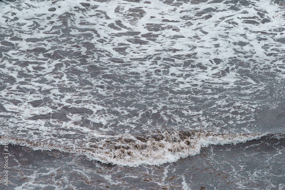 Photography of oceanic shore. Soft surf, waves and water surface. Natural background. Concepts of beauty in nature and tourism and touristic time. Photography of oceanic shore. Soft surf, waves and water surface. Natural background. Concepts of beauty in nature and tourism and touristic time.