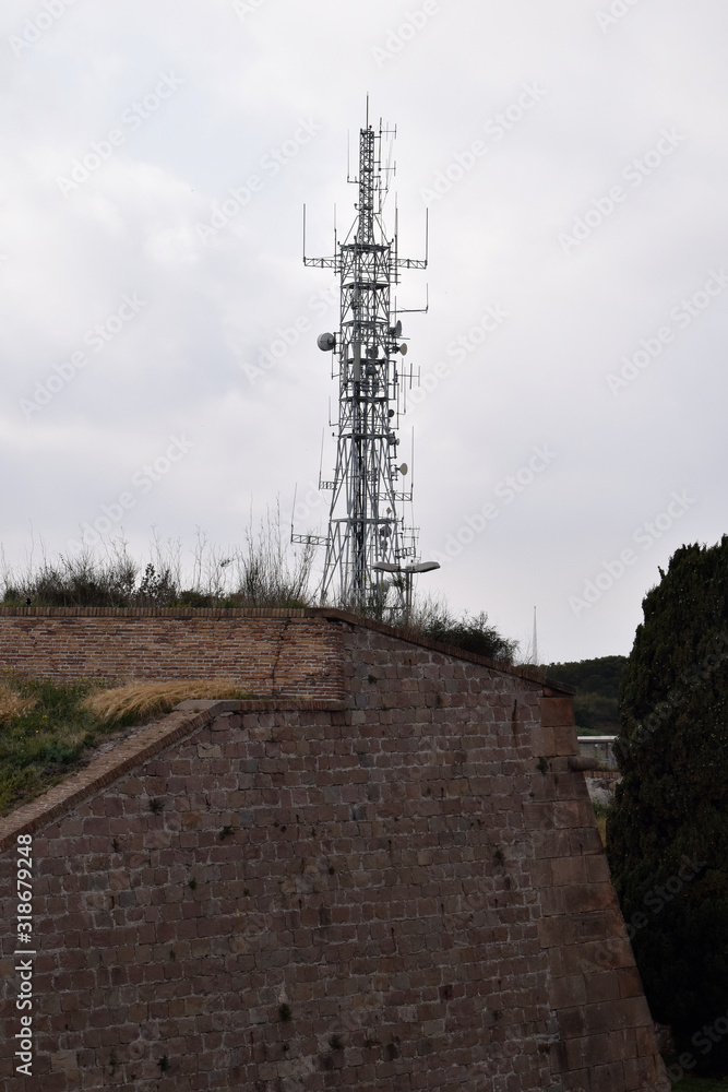 Tall Steel Telecommunications Mast with Aerials on Old Stone Fortress 