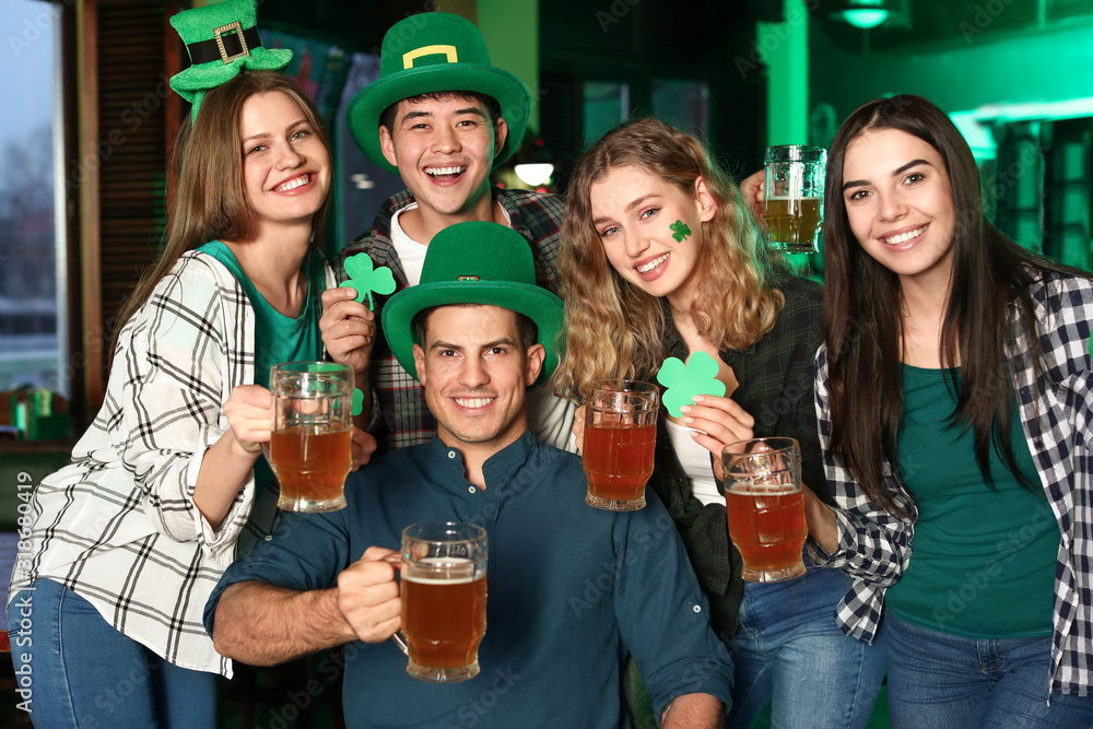 Young friends celebrating St. Patrick's Day in pub