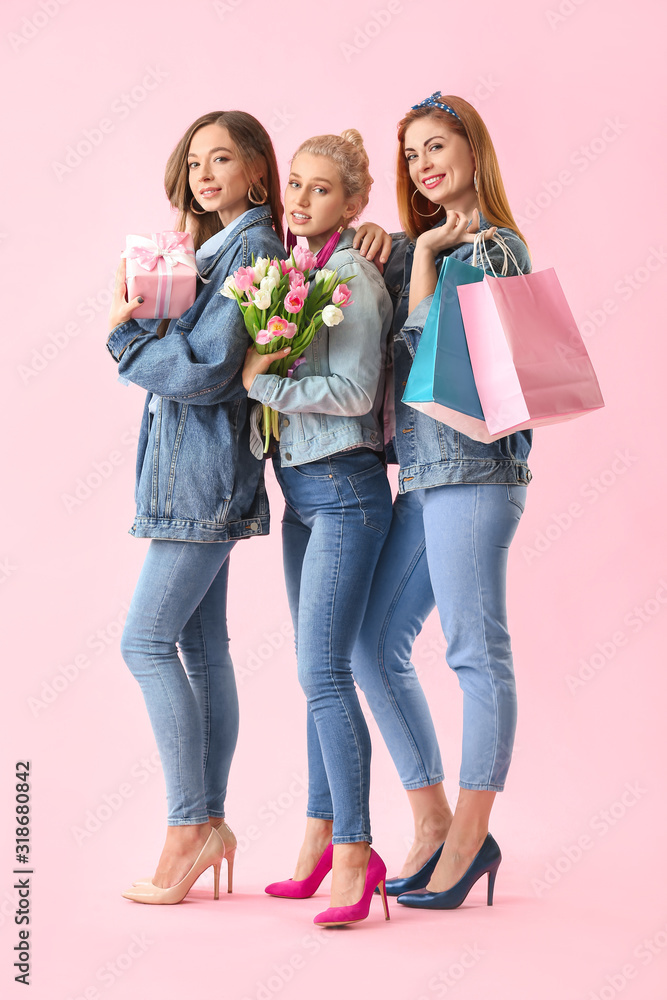 Beautiful young women with gifts on color background. International Women's Day celebration Beautiful young women with gifts on color background. International Women's Day celebration