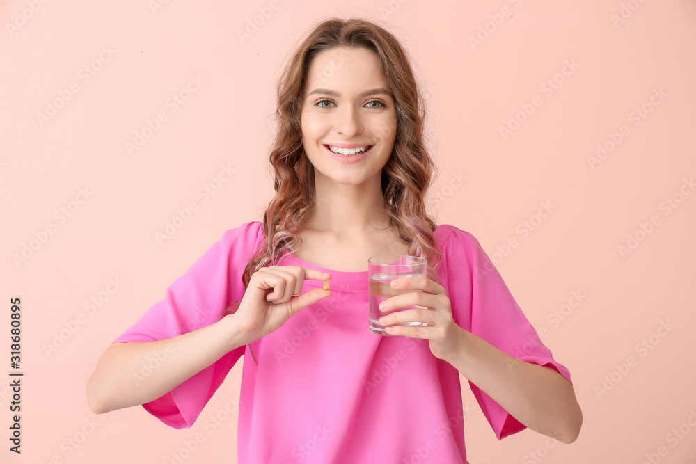 Young woman with fish oil on color background Young woman with fish oil on color background