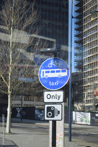 Wallpaper Mural Traffic Signs on Steel Pole beside Road with Reflections in Glass Window  Torontodigital.ca