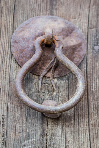 a rusty handle of an old wooden door