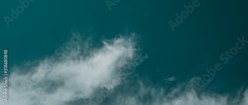 Abstract background in the form of sky and irregular clouds the dominant color aqua menthe. A rough background for all inspirational designs.