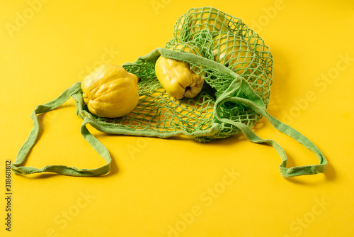 Quince fruits in reusable shopping bag. No plastic waste concept