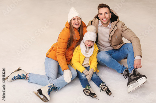 Happy family on skating rink