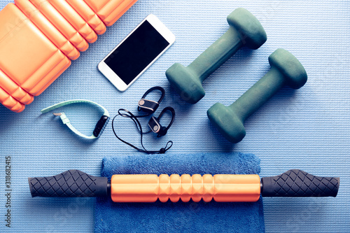 fitness and recovery equipment on a yoga mat