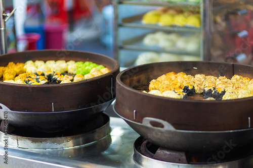 Photography Colorful steamed dim sum, chinese dumpling in a wooden steamer