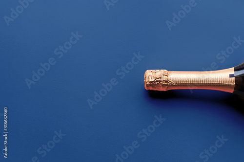 Champagne bottle on classic blue background