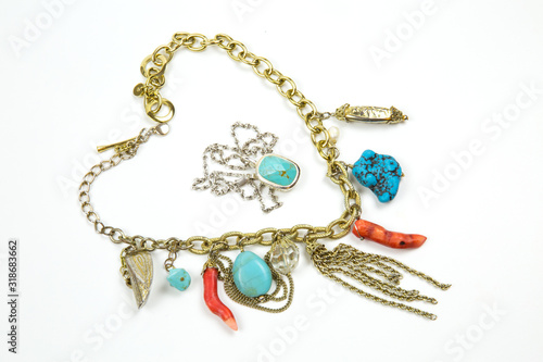 Necklace made of bright colored coral turquoise stones with metal chain Keychain with turquoise. Selective focus. Jewelry Fashion and beauty.