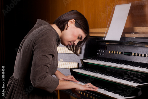Organist playing a pipe organ, closeup view photo