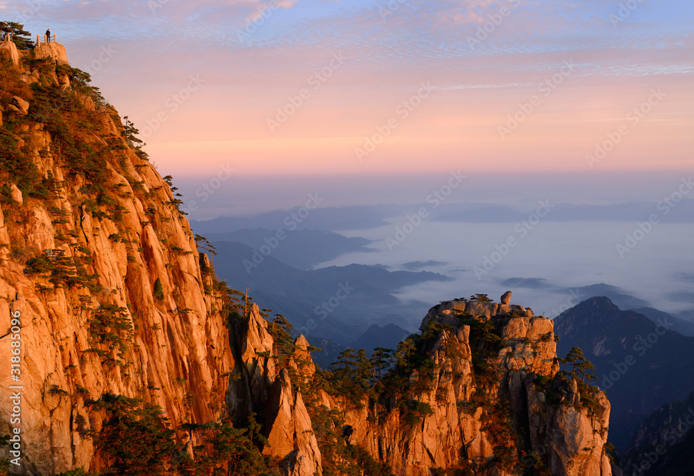 Lion Peak and Stone Monkey watching the Sea Peak at first light with fog in valley at Huangshan Mountains China Lion Peak and Stone Monkey watching the Sea Peak at first light with fog in valley at Huangshan Mountains China