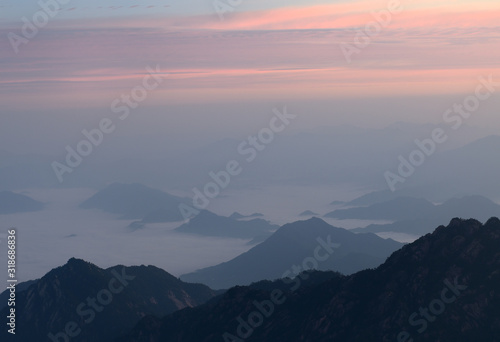 Pink glow at sunrise with fog in valley at North Sea area Huangshan Mountain China