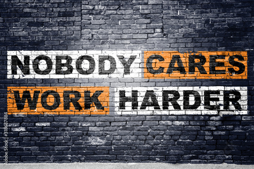 Obraz na plátně Nobody cares work harder saying lettering Graffiti on Brick Wall