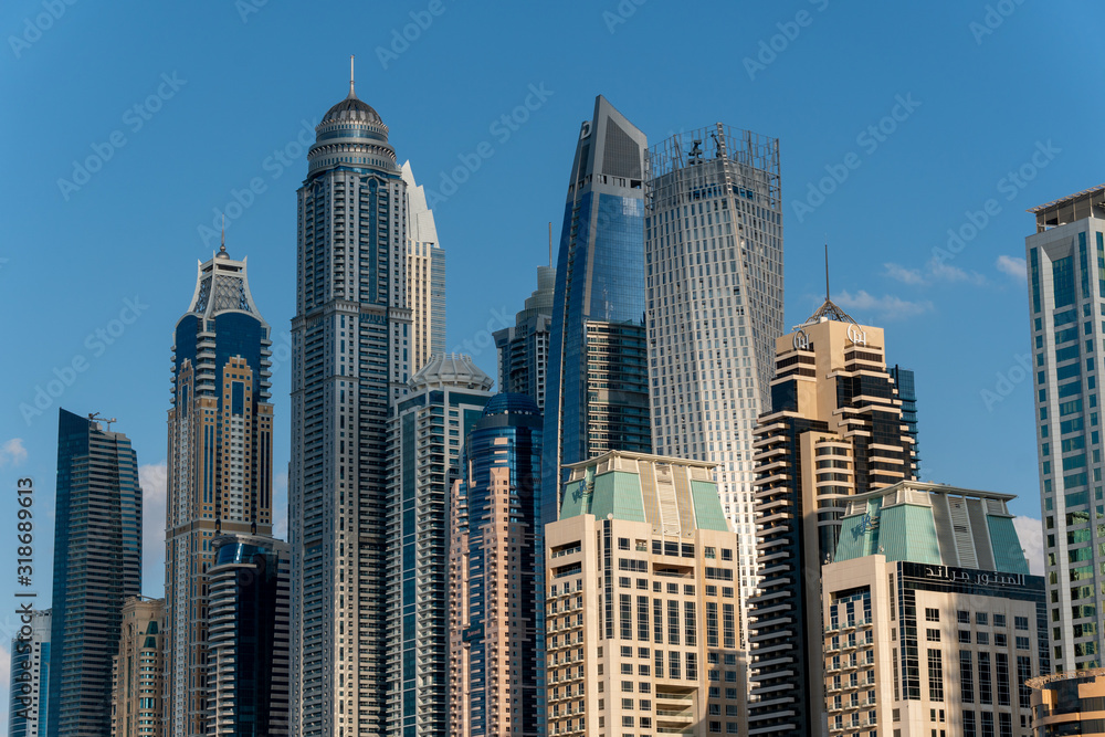 Daytime view to the Iconic panorama of Dubai Marina, UAE. Modern hotels, luxury apartments, business centers and famous tourists attraction.