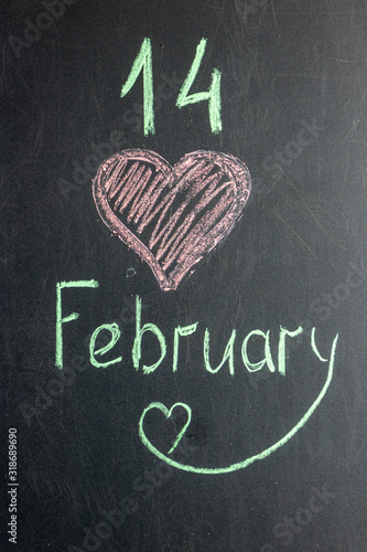 The inscription on the chalk board February 14th. Valentine's Day photo