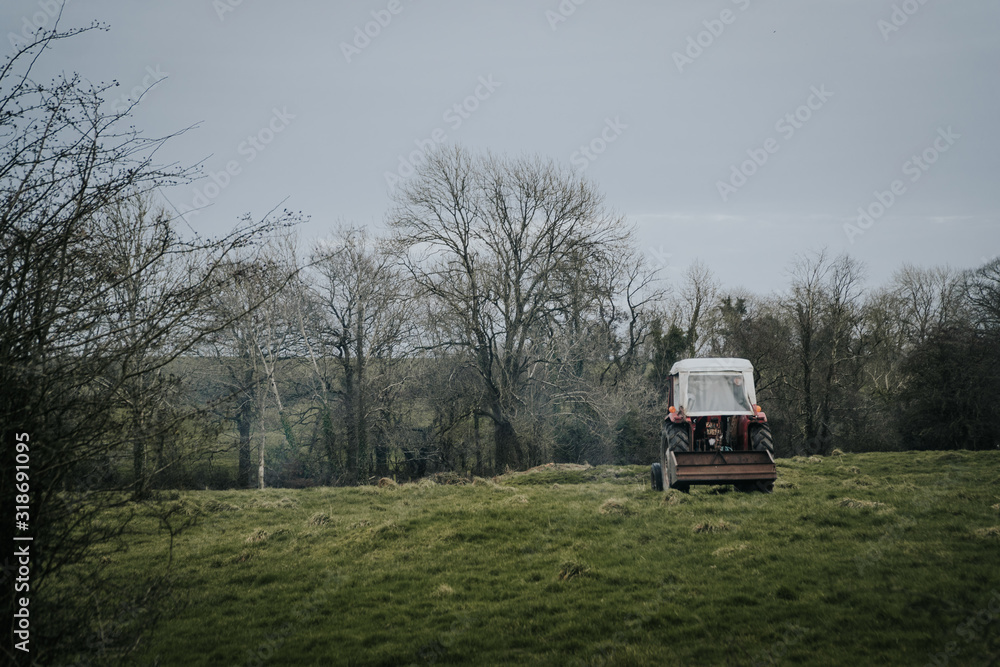 Old tractor in a green field in Ireland
