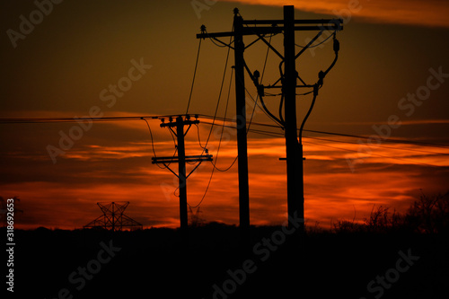 Silhouette pole line into the sunset