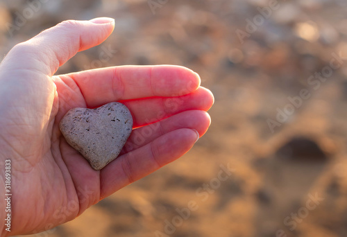 heart of natural stone in a woman's hands