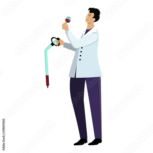 Male winemaker in lab coat takes a sample of wine using a pipette at the winery.