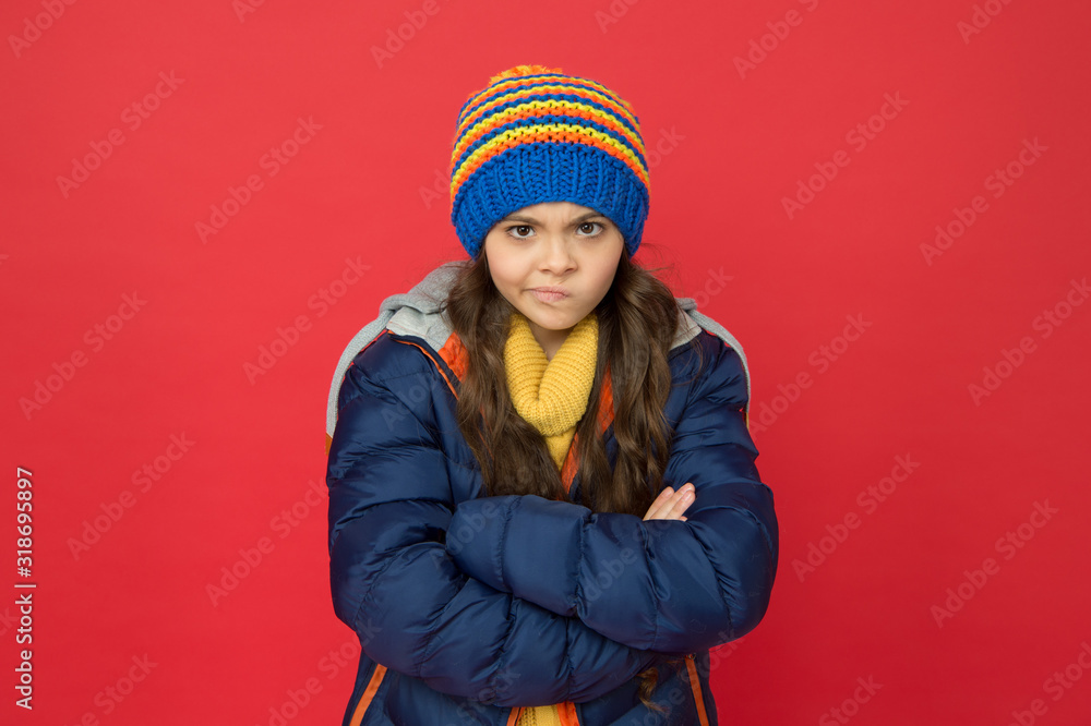 I do not think so. Strict and serious baby. Little girl wear winter clothes red background. Childhood concept. Emotional girl long hair knitted hat. Teen girl casual style. Emotions and mood