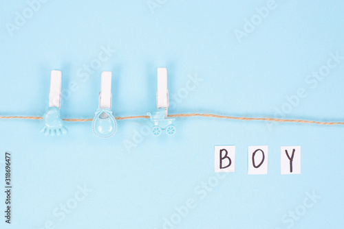 Invitation for shower party concept. Top view photo of background with clothespins and inscription boy on it