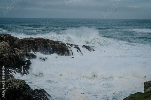 The waves of the ocean hit the rocks with small splashes