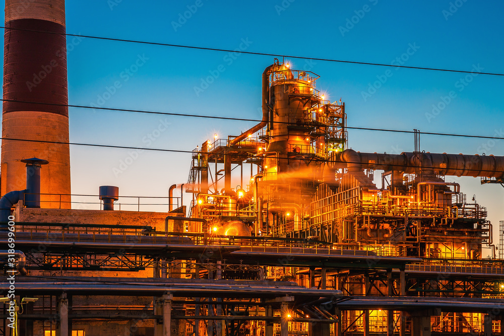Oil petrochemical refinery factory or plant at twilight after sunset.