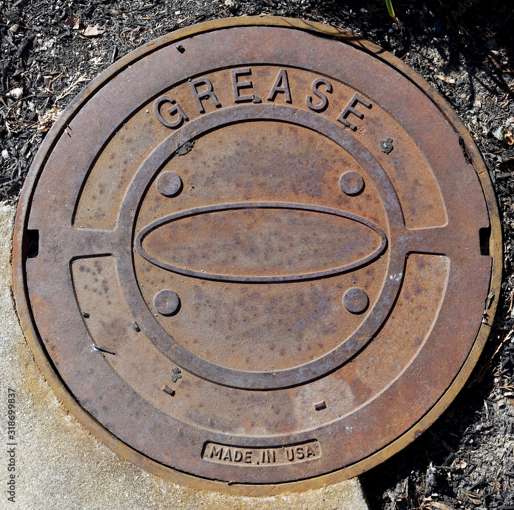 Rusty industrial metal grease cover.