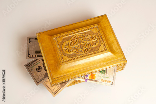 Silver dollar banknots in the treasure trove, wooden chest, gift, decoration on dark paper background. photo