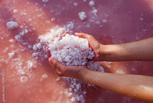 Medicinal salt from a pink lake in the hands of a girl
