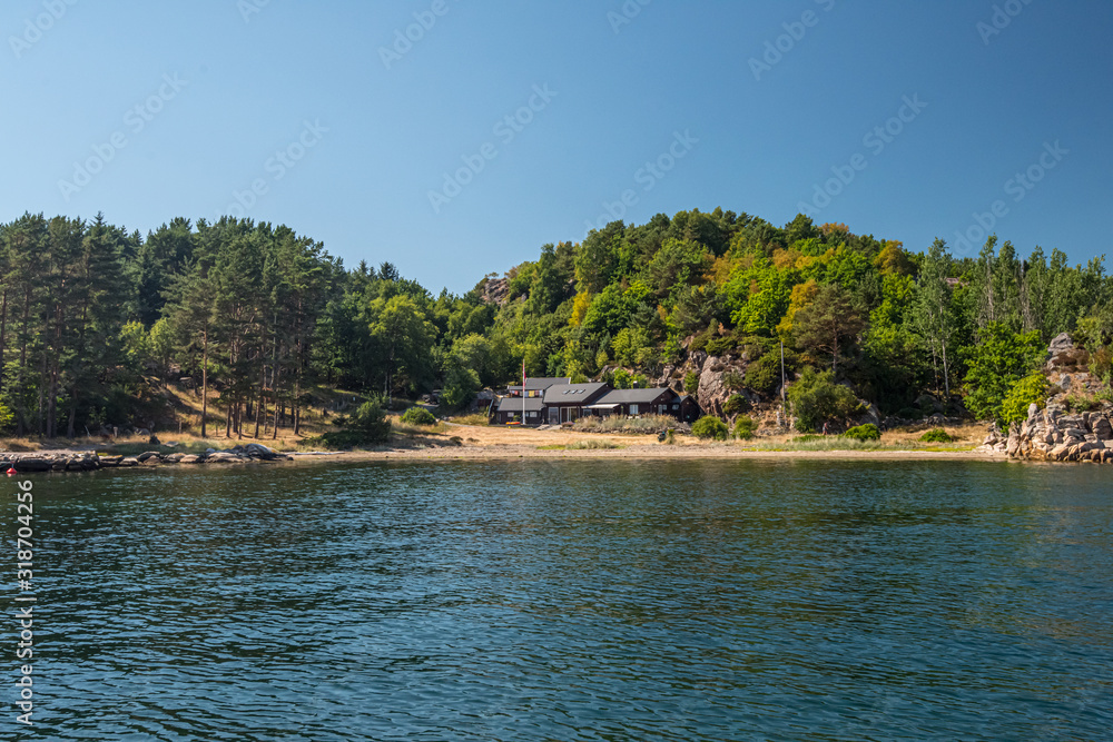 Beautiful summer house in a small bay with a sand beach.