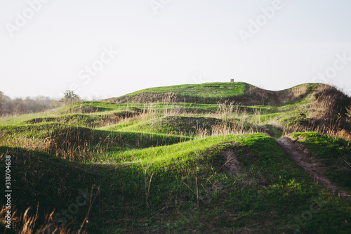 Dry and green grass in sunset rays at Donetske Horodyshche