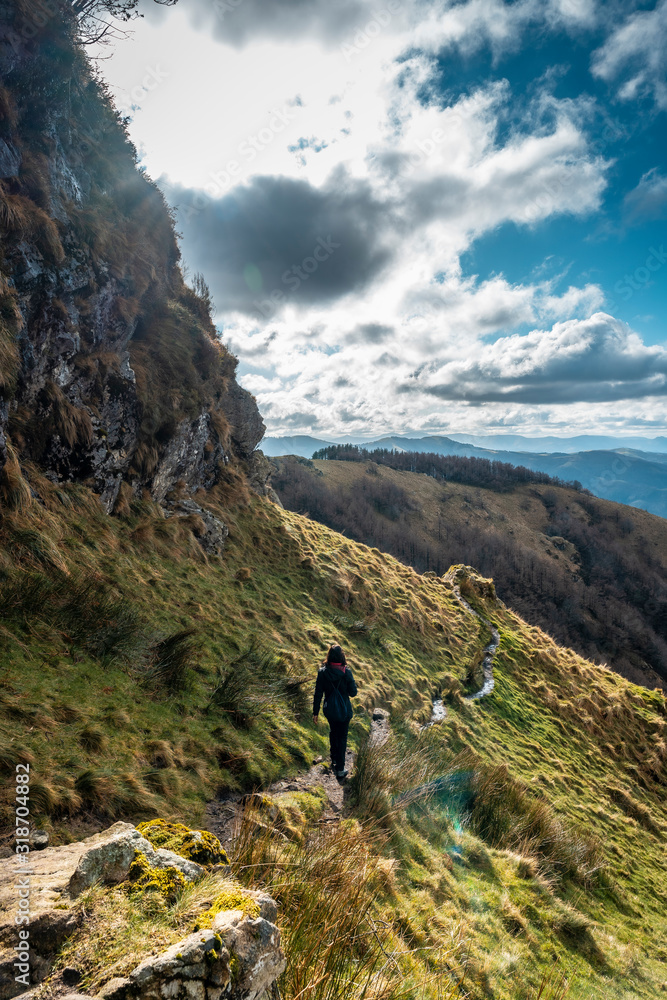 A young woman on the path to the top of Peñas de Aia or Aiako Harrriak, Gipuzkoa. Basque Country