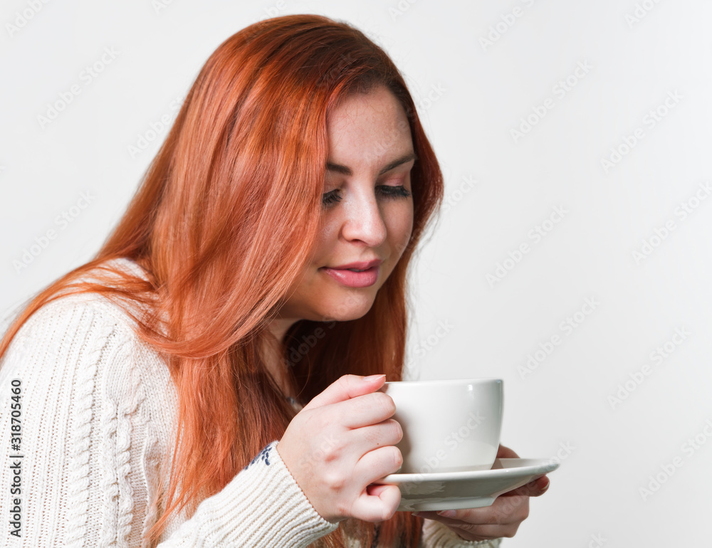 A woman with freckles drinking coffee A woman with freckles drinking coffee