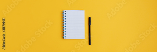 Wide view image of blank spiral note pad and black marker