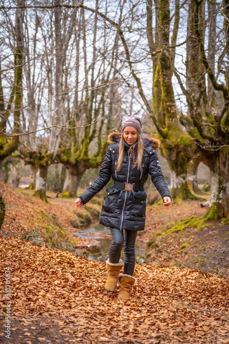 A young woman enjoying in the Otzarreta Forest in the natural park of Gorbea, Bizkaia. Basque Country © unai