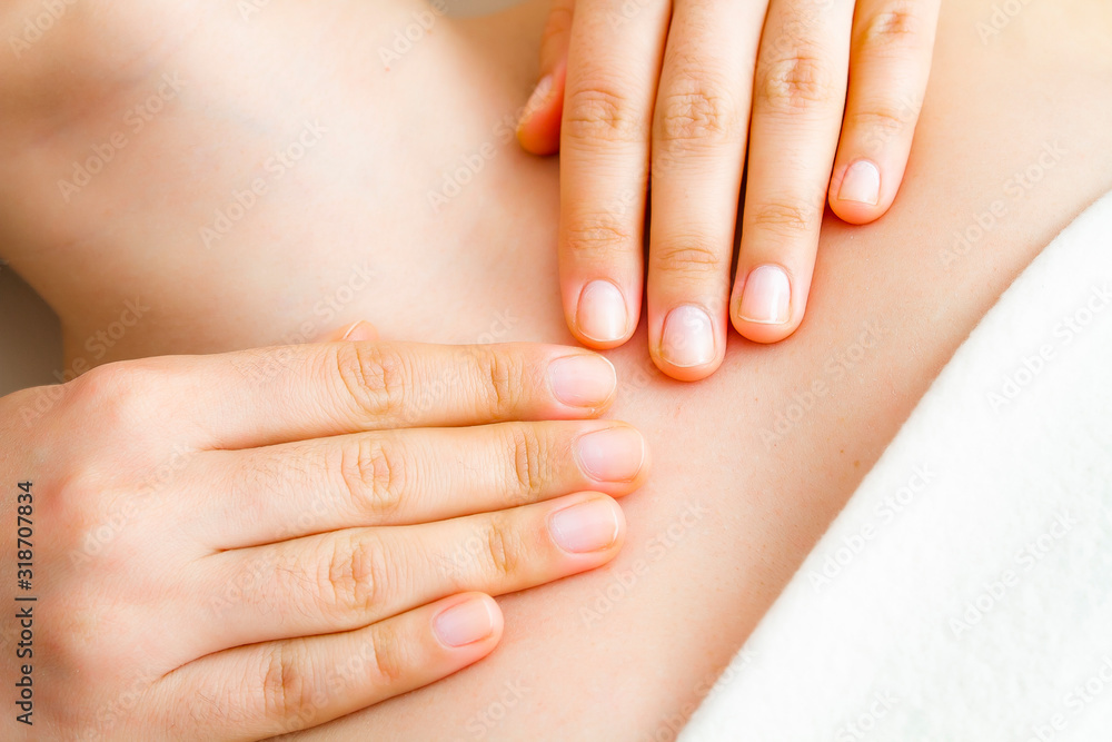 Hands of a massage therapist close-up. Body massage.