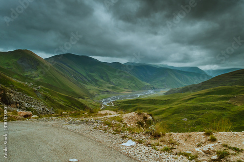 Cycling mountain road. Misty mountain road in high mountains.. Cloudy sky with mountain road