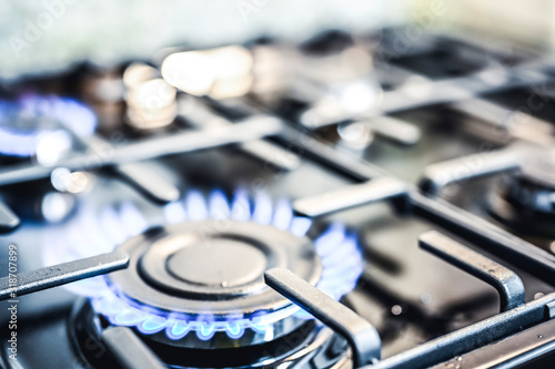 Kitchen stove cook. Kitchen gas cooker with burning blueflames fire propane gas. photo