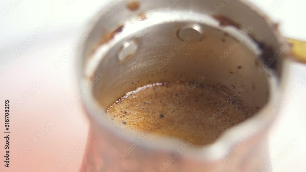 Turkish coffee foam raising in Ibrik copper Cezve on electric stove closeup Turkish coffee foam raising in Ibrik copper Cezve on electric stove closeup