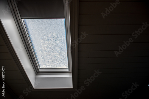 Roof window seen from the inside on a cold day.