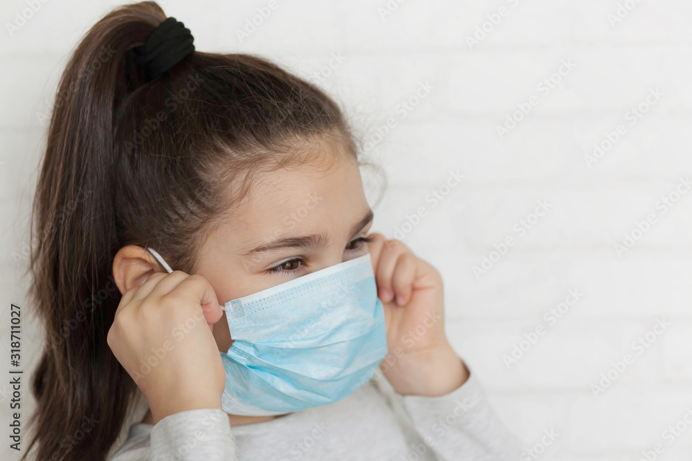 Child in a sterile medical mask. Sick little girl. Epidemic of flu. Virus, coronavirus.